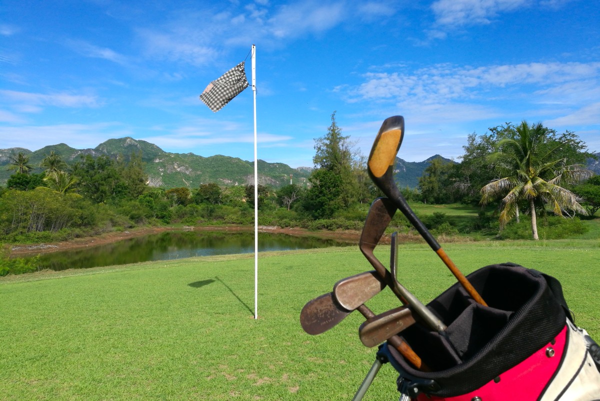 hickory-shafted golf clubs on the 4th green at a course in Thailand